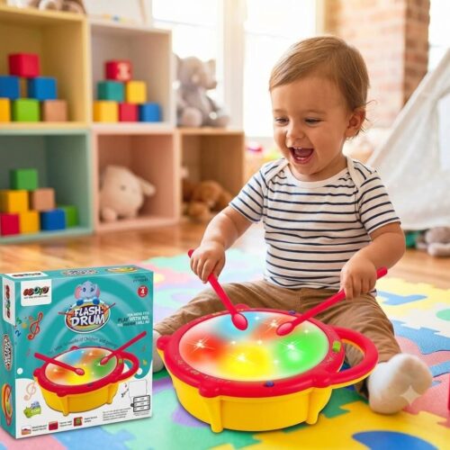 Retail packaging box for the GOOYO Flash Drum musical toy, featuring a cute blue elephant logo and showcasing a yellow drum with a multi-colored illuminated top and two red drumsticks. Text on the box highlights features including 3 play modes, volume control, music switches, and an age 4+ recommendation.