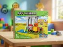 Retail box for the 8-in-1 "MY WORLD" building toy (Model 44108B) sitting on a wooden table, featuring a pixelated video game-style landscape, a blocky character, 67+ PCS, and a 6+ age rating.
