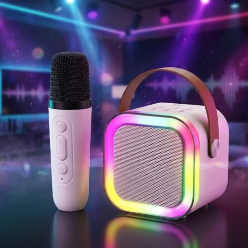 A white MZ S664 Wireless Speaker with a brown carrying strap and an illuminated RGB LED ring, sitting next to a white wireless microphone and its blue retail packaging box in a neon-lit party setting.